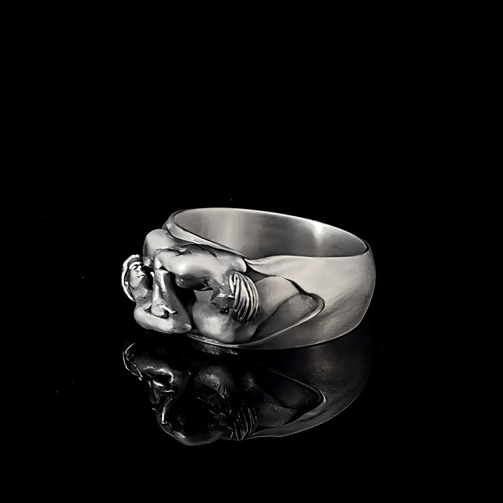 Sterling silver ring with a detailed gay couple design on a black background