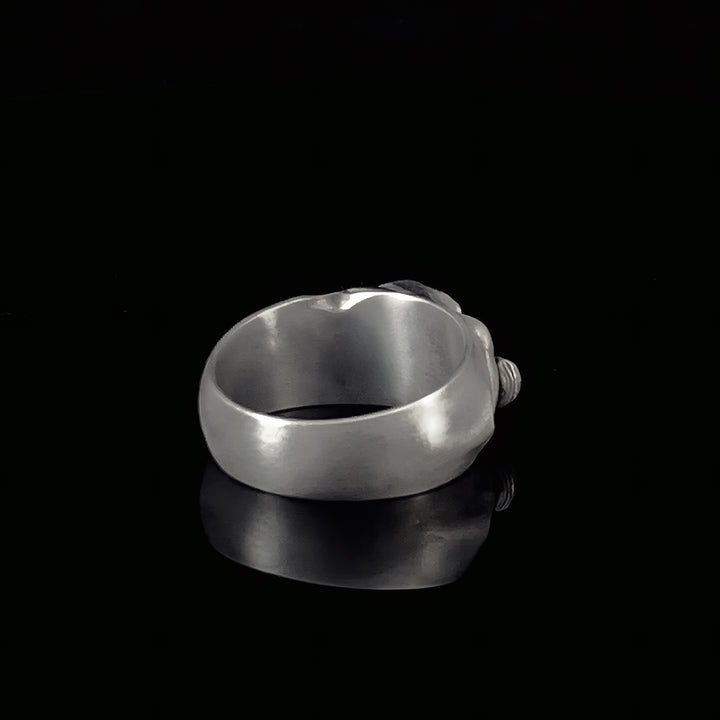 Sterling silver band ring on a black background