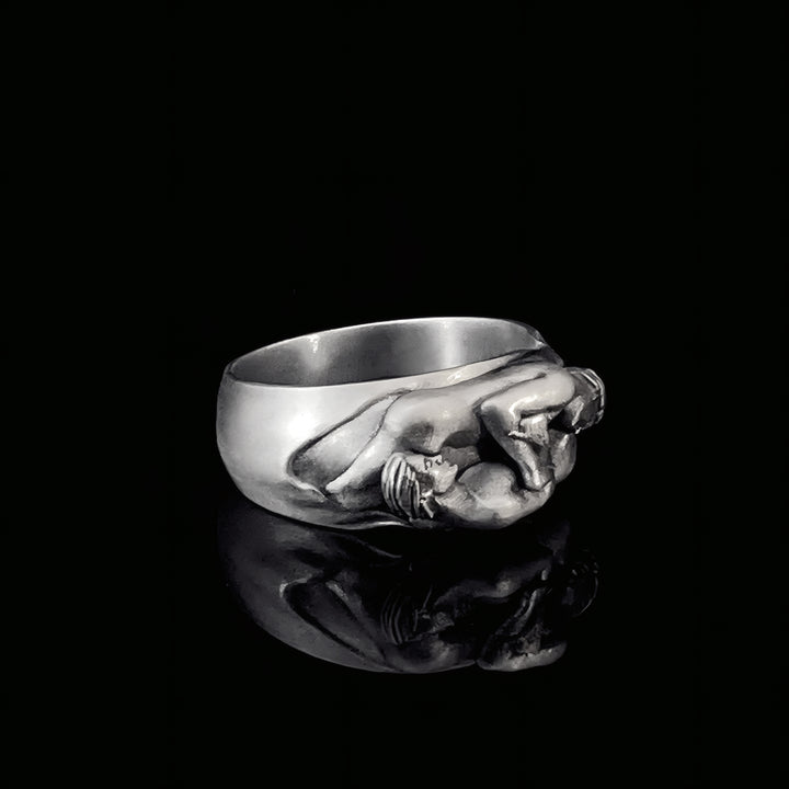 Sterling silver ring with a detailed gay couple design on a black background