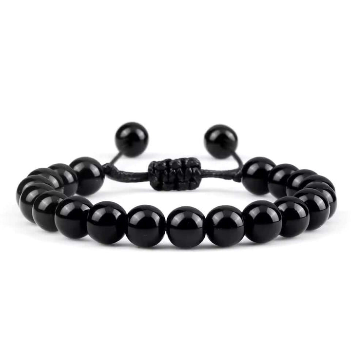 Adjustable black men's bracelet made of natural onyx beads, perfect for layering with necklaces or rings.