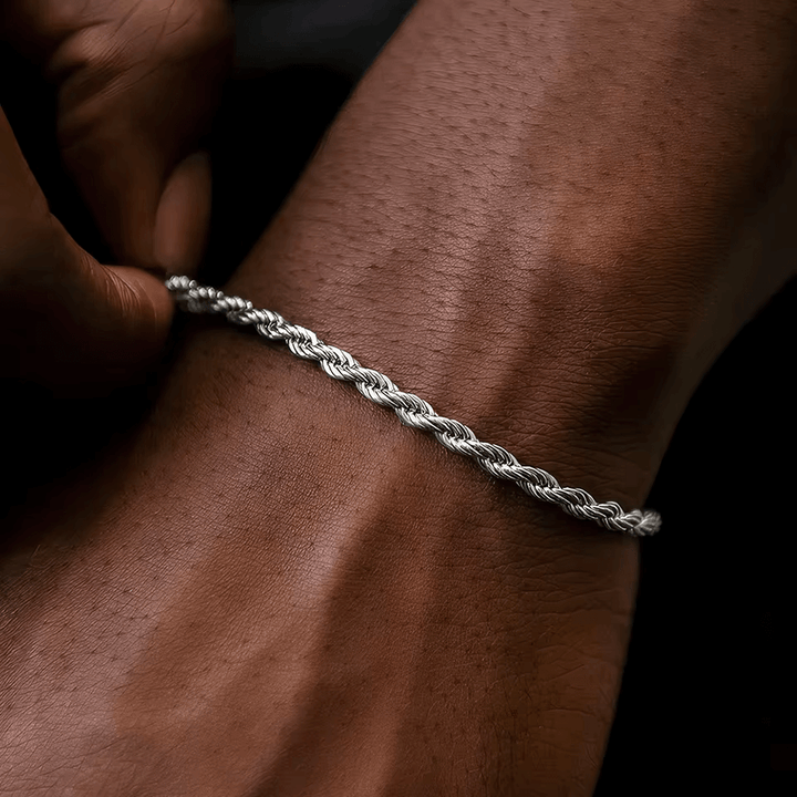 Twisted rope chain bracelet in sterling silver worn on a man's wrist, showcasing elegant jewelry design.