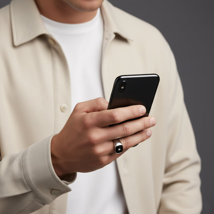 Person holding a smartphone with a neutral background