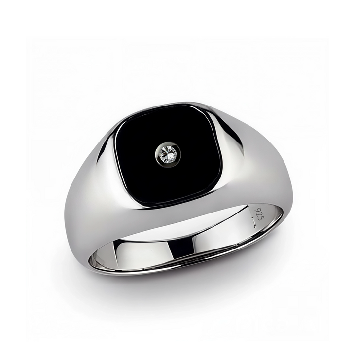 Silver ring with a black square stone and diamond on a white background