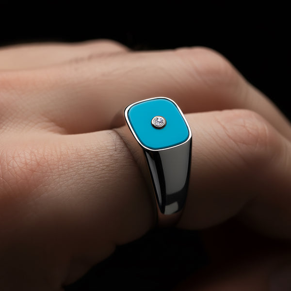 Ring with blue square stone and silver band on a finger against a dark background